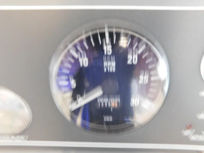 Slide: The Image of Blurry tachometer gauge on a 1999 Tiara Yachts 3500 Express dashboard. - 22