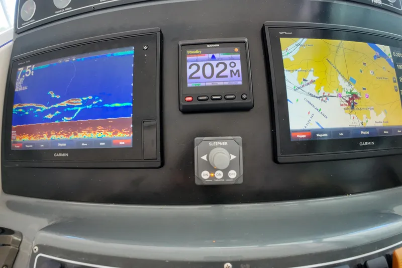 Slide: The Image of 1999 Tiara Yachts 3500 Express dashboard with Garmin navigation displays. - 229