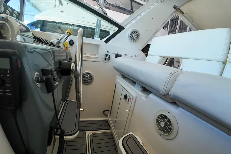 Slide: The Image of 1999 Tiara Yachts 3500 Express interior with steering wheel and seating area. - 233