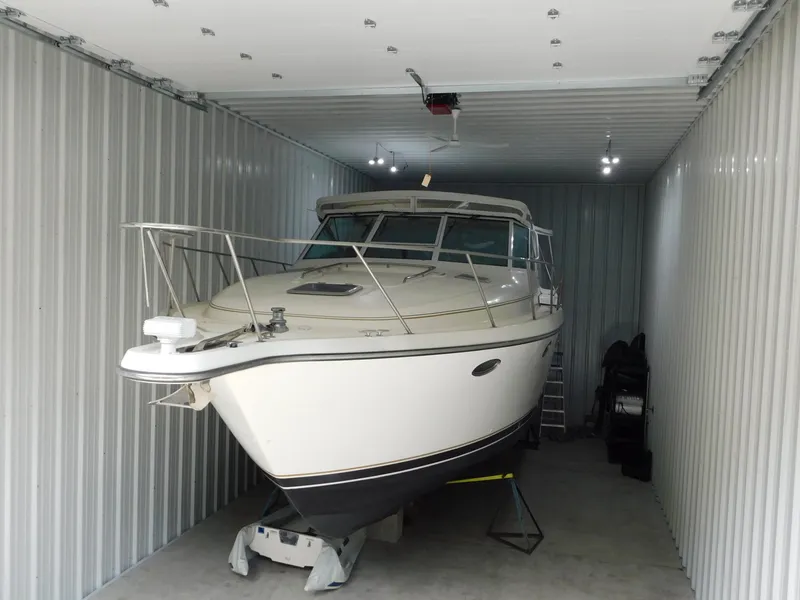 Slide: The Image of 1999 Tiara Yachts 3500 Express stored in a metal garage. - 3