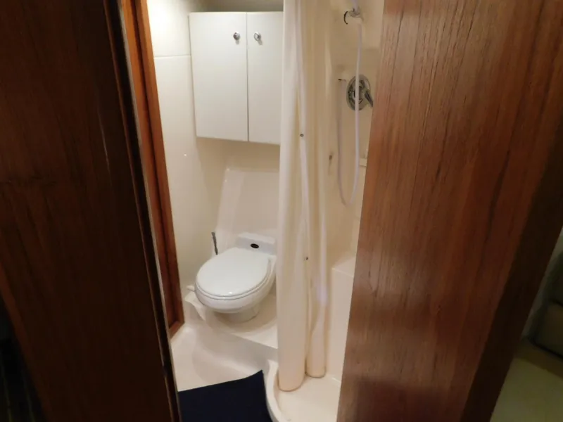 Slide: The Image of Bathroom interior of 1999 Tiara Yachts 3500 Express, featuring toilet and shower. - 30