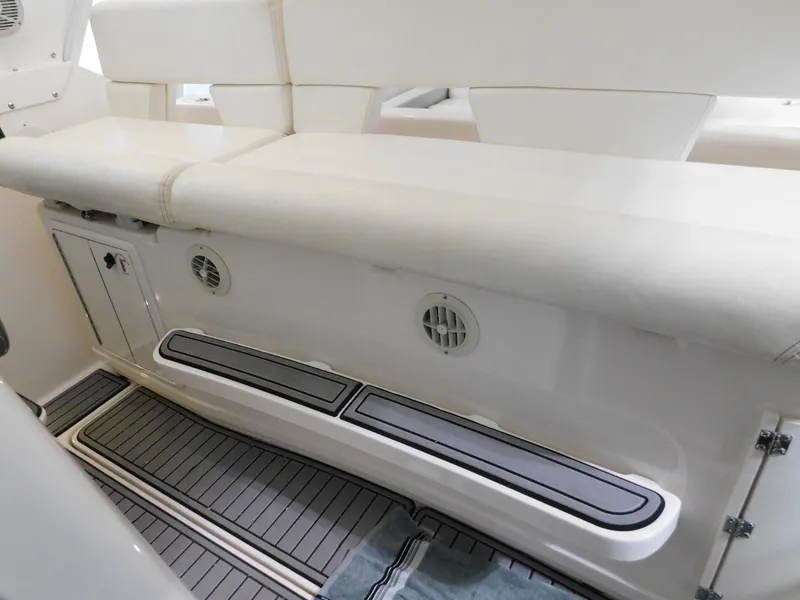 Slide: The Image of 1999 Tiara Yachts 3500 Express interior seating with white upholstery and storage compartments. - 34