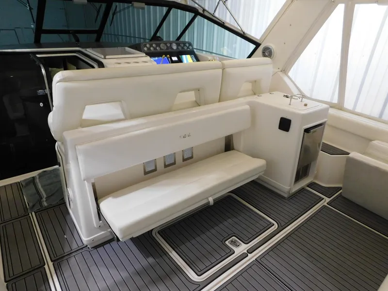 Slide: The Image of 1999 Tiara Yachts 3500 Express interior with white seating and modern dashboard. - 35