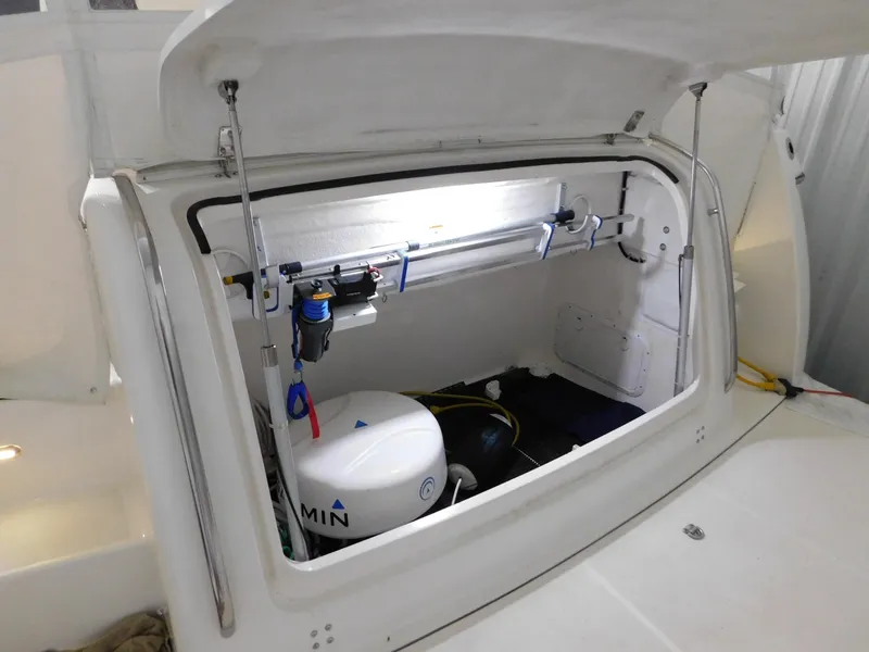 Slide: The Image of Open storage compartment on 1999 Tiara Yachts 3500 Express, featuring equipment and gear. - 38