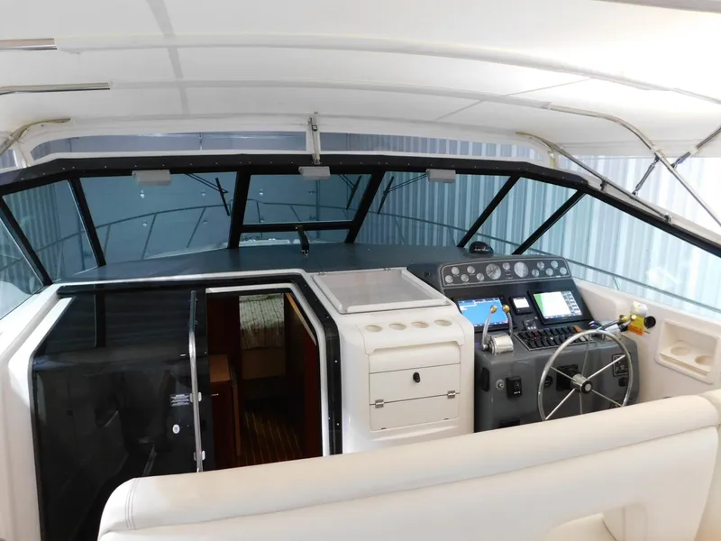 Slide: The Image of 1999 Tiara Yachts 3500 Express cockpit with steering wheel and control panel. - 4