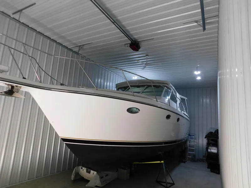 Slide: The Image of 1999 Tiara Yachts 3500 Express stored in a metal-walled indoor facility. - 41