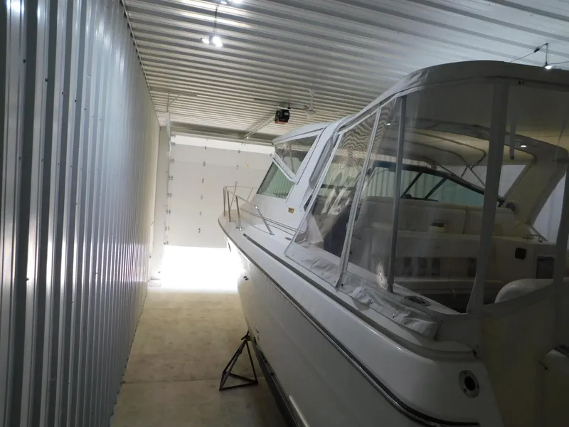 Slide: The Image of 1999 Tiara Yachts 3500 Express stored in a metal garage. - 44