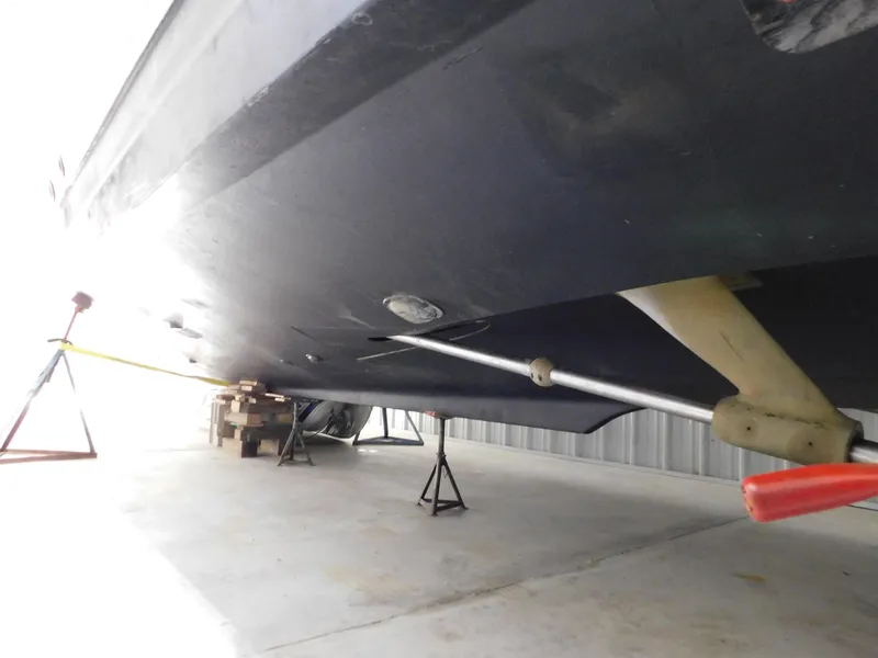Slide: The Image of 1999 Tiara Yachts 3500 Express boat hull on stands in storage facility. - 47