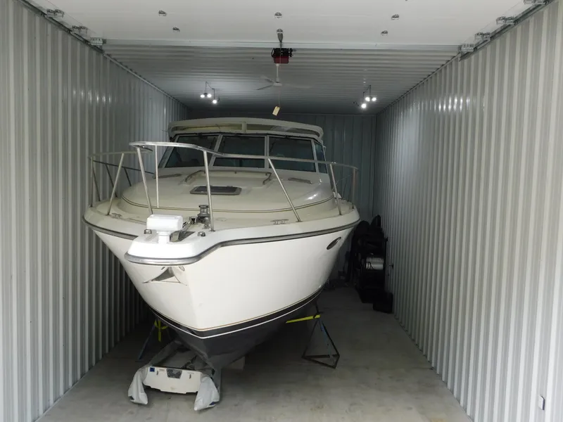 Slide: The Image of 1999 Tiara Yachts 3500 Express stored in a metal garage. - 49