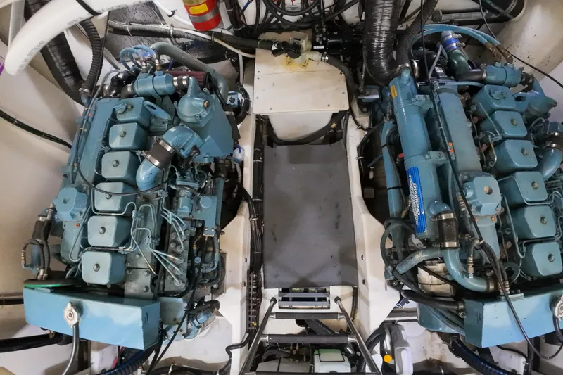 Slide: The Image of Engine room of a 1999 Tiara Yachts 3500 Express, featuring dual marine engines. - 67