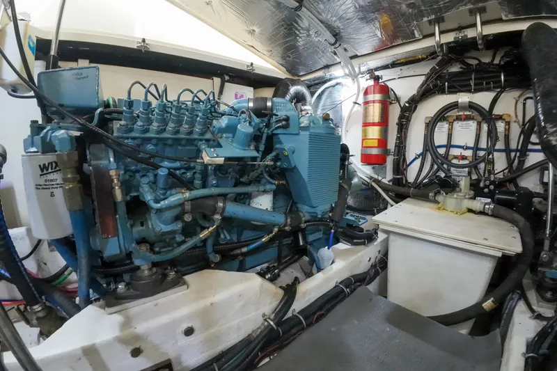 Slide: The Image of Engine room of 1999 Tiara Yachts 3500 Express, featuring detailed mechanical components. - 74