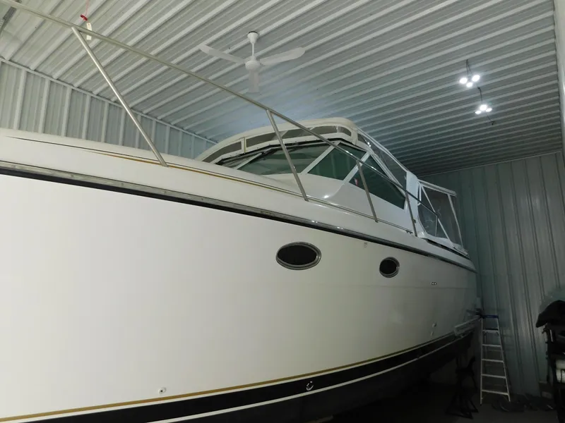 Slide: The Image of 1999 Tiara Yachts 3500 Express in storage, showcasing sleek design and white exterior. - 8