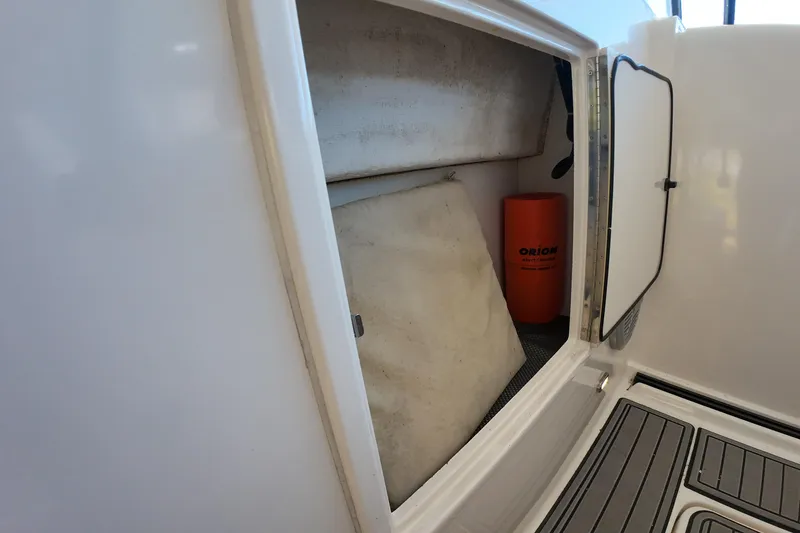 Slide: The Image of Storage compartment on a 1999 Tiara Yachts 3500 Express, featuring safety equipment. - 81