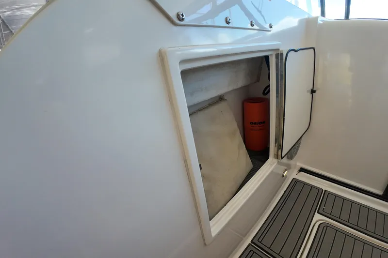 Slide: The Image of 1999 Tiara Yachts 3500 Express storage compartment with safety equipment. - 82