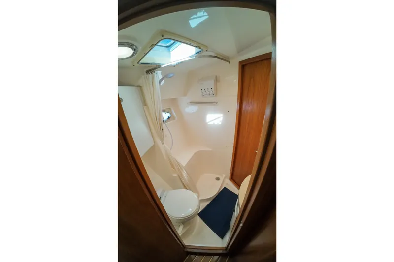 Slide: The Image of Bathroom interior of 1999 Tiara Yachts 3500 Express with shower and toilet. - 91