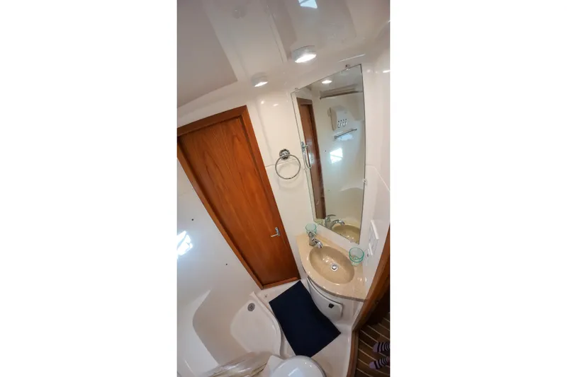 Slide: The Image of Bathroom interior of 1999 Tiara Yachts 3500 Express with sink and mirror. - 95