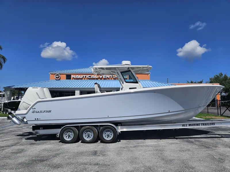 The Image of 2024 Sailfish 312CC boat on a triple-axle trailer at Nautical Ventures. - 0