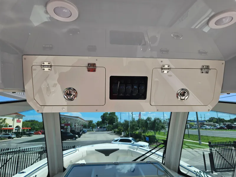 Slide: The Image of 2024 Sailfish 312CC boat console with storage compartments and control panel. - 22