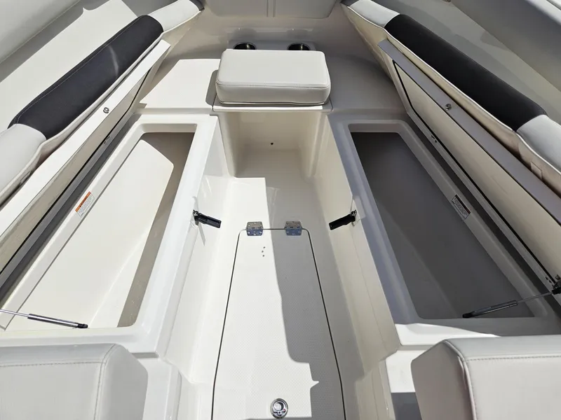 Slide: The Image of 2024 Sailfish 312CC boat interior with storage compartments and seating. - 38