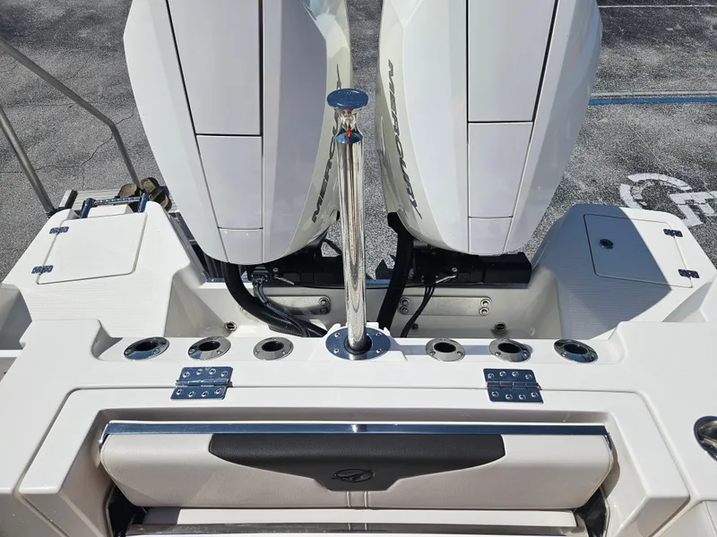 Slide: The Image of 2024 Sailfish 312CC boat with dual outboard engines and fishing rod holders. - 9