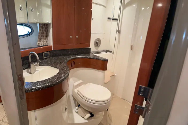 Slide: The Image of Luxurious bathroom in 2004 Formula 48 Yacht with modern fixtures and wood accents. - 10