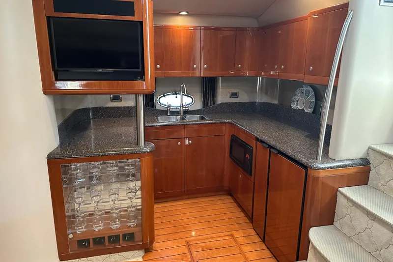 Slide: The Image of Luxurious 2004 Formula 48 Yacht kitchen with wood cabinetry, granite countertops, and modern appliances. - 13