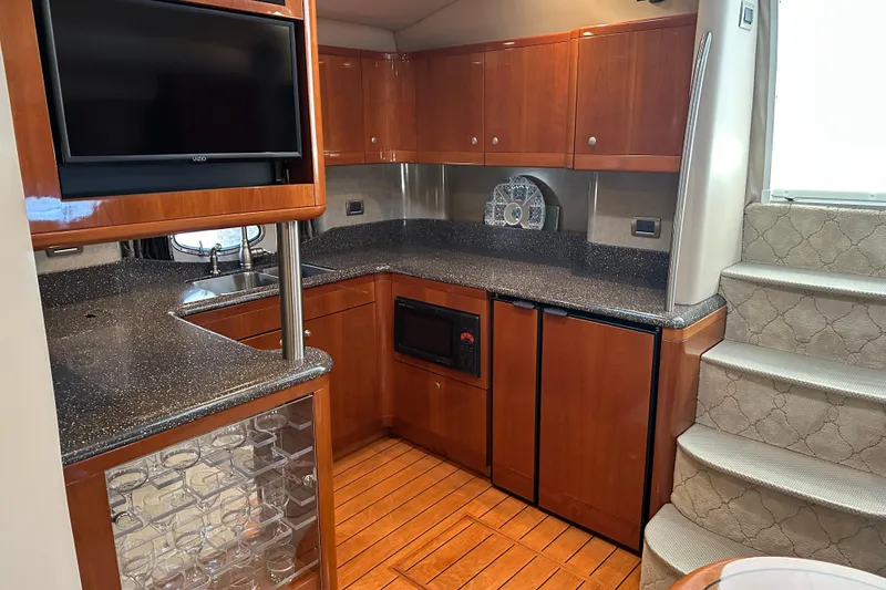 Slide: The Image of Luxurious 2004 Formula 48 Yacht interior kitchen with wood cabinetry and modern appliances. - 14