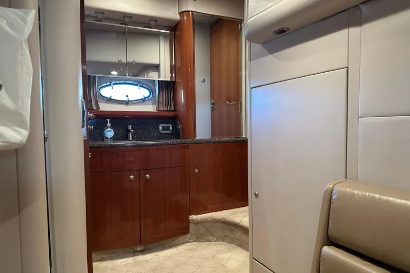 Slide: The Image of Luxurious bathroom interior of a 2004 Formula 48 Yacht with wood cabinetry and porthole window. - 25