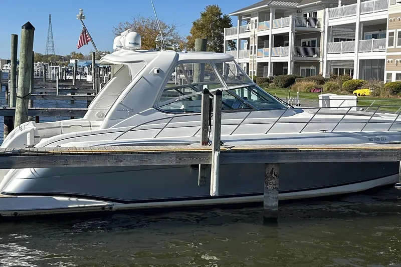 Slide: The Image of 2004 Formula 48 Yacht docked near waterfront apartments. - 3