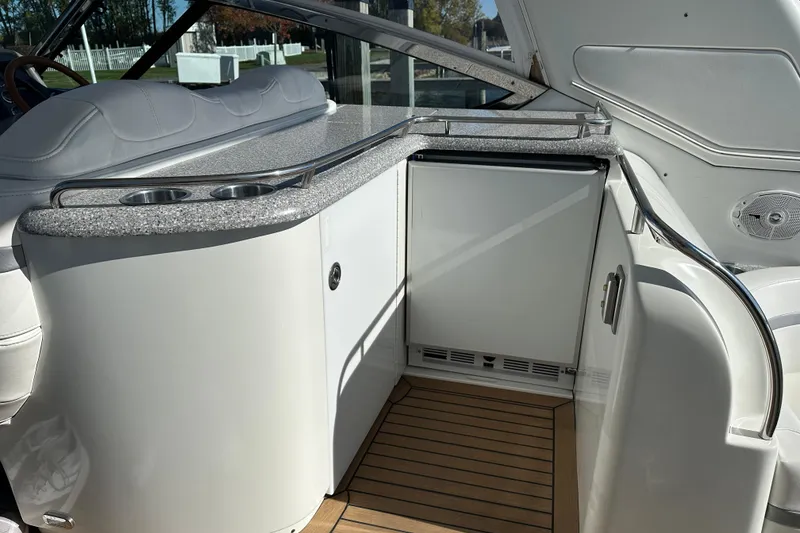 Slide: The Image of 2004 Formula 48 Yacht interior with kitchenette, featuring countertop and built-in fridge. - 32