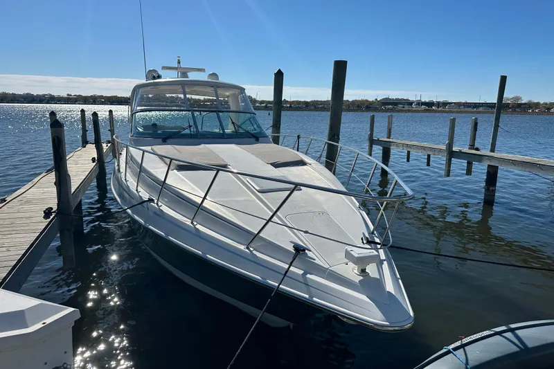 Slide: The Image of 2004 Formula 48 Yacht docked at a marina under clear blue skies. - 4