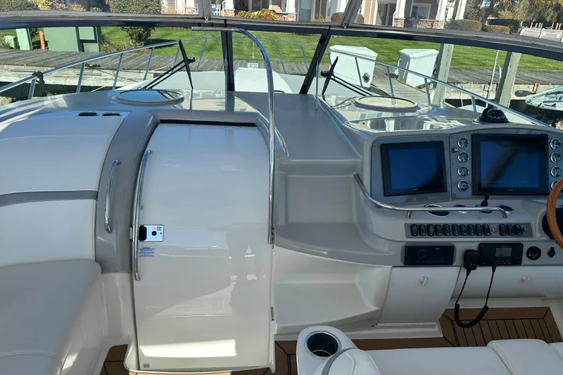Slide: The Image of 2004 Formula 48 Yacht cockpit with dual screens and sleek controls. - 42