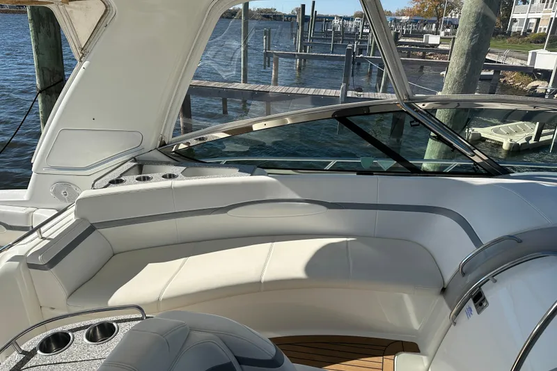 Slide: The Image of 2004 Formula 48 Yacht interior with white seating and cup holders, dockside view. - 43