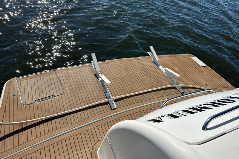 Slide: The Image of 2004 Formula 48 Yacht with wooden deck, sparkling water in the background. - 45