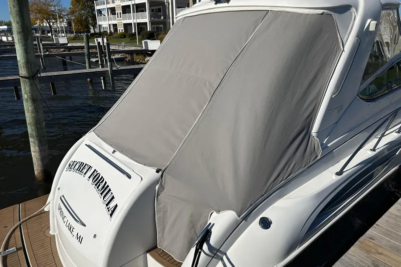 Slide: The Image of 2004 Formula 48 Yacht docked with protective cover, labeled "Secret Formula," Spring Lake, MI. - 52