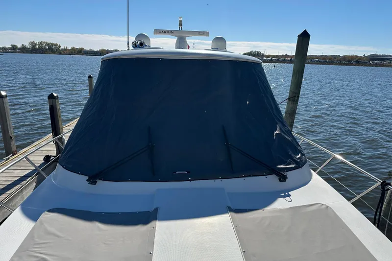 Slide: The Image of 2004 Formula 48 Yacht docked by the water on a sunny day. - 53