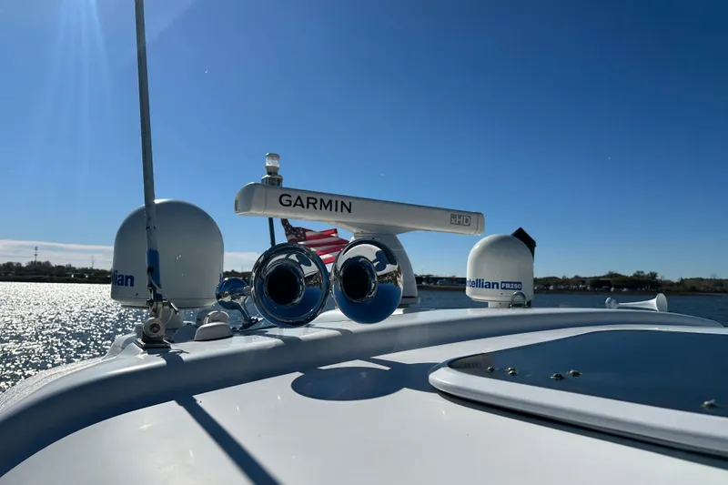 Slide: The Image of 2004 Formula 48 Yacht with Garmin radar, clear sky, and water view. - 56