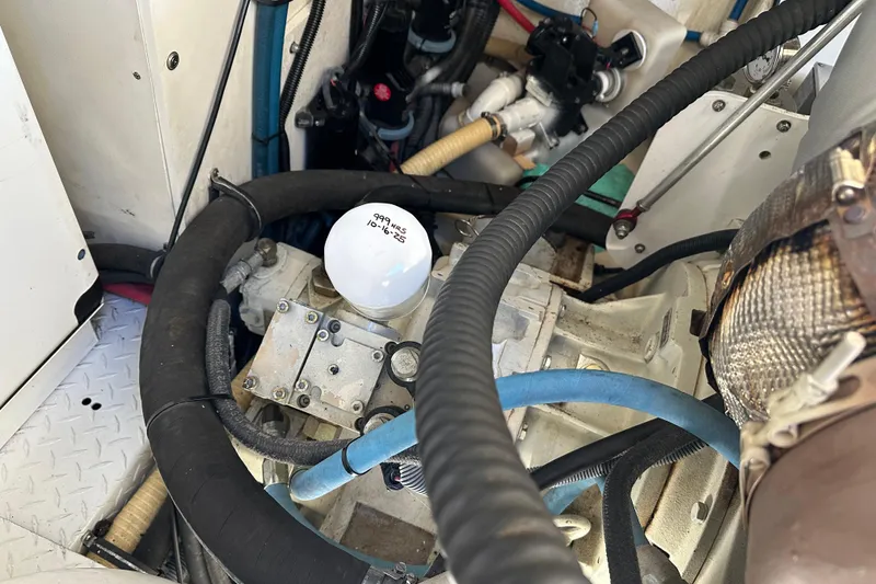 Slide: The Image of Engine compartment of a 2004 Formula 48 Yacht with visible hoses and components. - 64