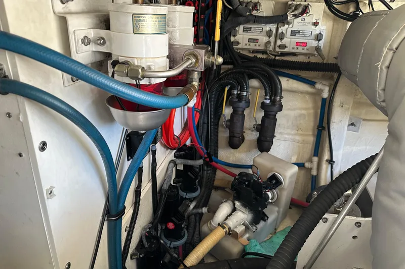 Slide: The Image of Engine room of a 2004 Formula 48 Yacht with visible hoses and components. - 65