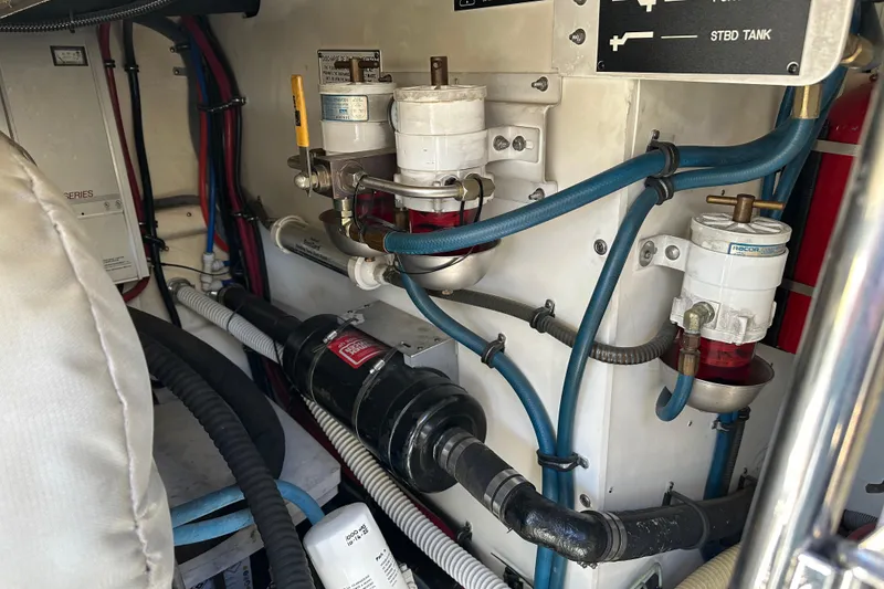 Slide: The Image of Engine room of a 2004 Formula 48 Yacht with visible fuel filters and hoses. - 66