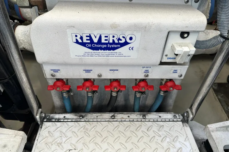 Slide: The Image of Reverso oil change system on 2004 Formula 48 Yacht, featuring multiple valves and hoses. - 69