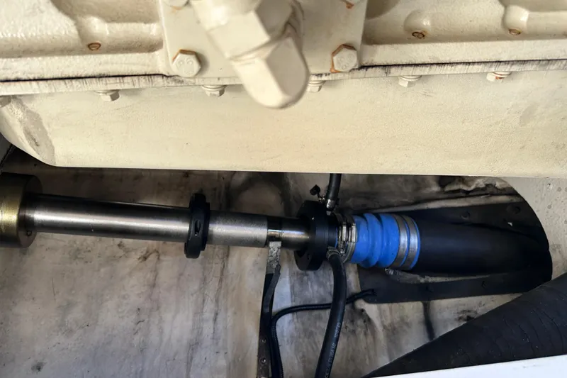 Slide: The Image of Engine compartment of a 2004 Formula 48 Yacht, featuring mechanical components and hoses. - 74