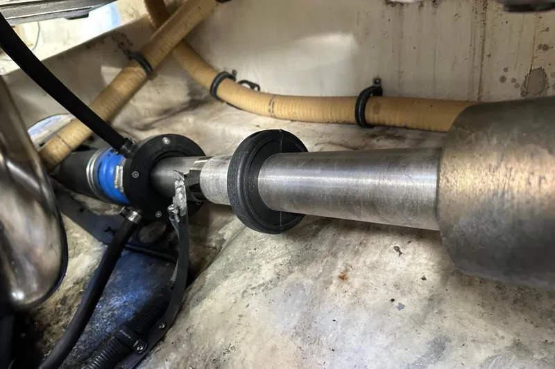 Slide: The Image of Engine compartment of a 2004 Formula 48 Yacht, showcasing mechanical components and hoses. - 75