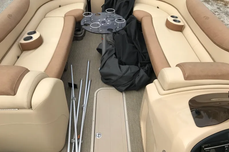 Slide: The Image of 2019 Avalon Catalina VRL boat interior with beige seating and cup holders. - 11