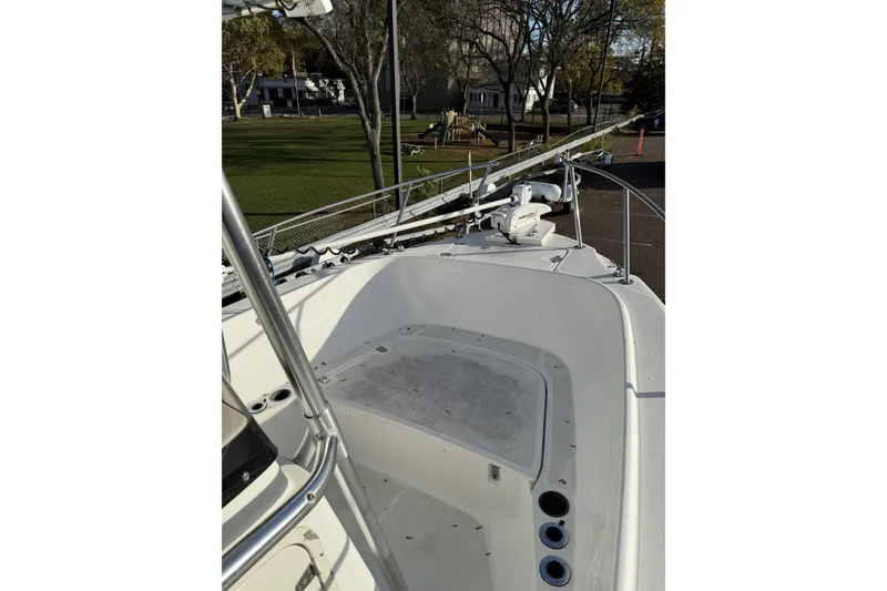 Slide: The Image of 2001 Boston Whaler 230 Outrage boat deck with railing and seating area. - 2