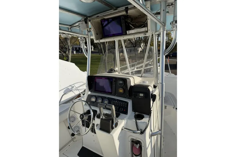 Slide: The Image of 2001 Boston Whaler 230 Outrage boat console with steering wheel and navigation equipment. - 3