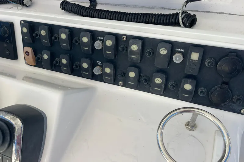 Slide: The Image of Control panel of a 2018 Southport 33 FE boat with various switches and dials. - 11