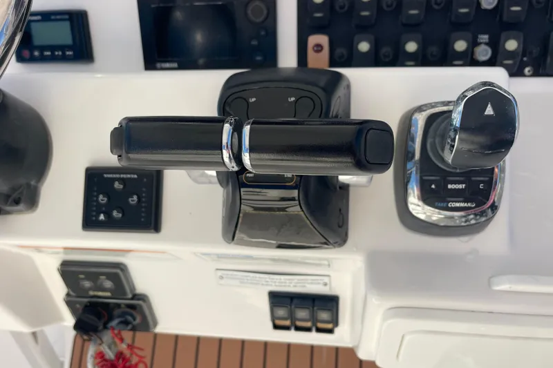 Slide: The Image of Control panel of a 2018 Southport 33 FE boat with throttle and joystick. - 12