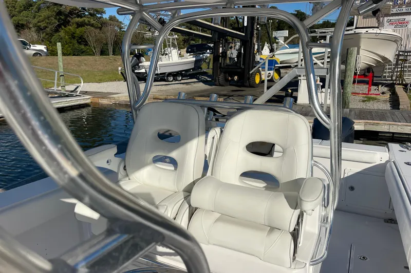 Slide: The Image of 2018 Southport 33 FE boat with white leather seats at a marina. - 17