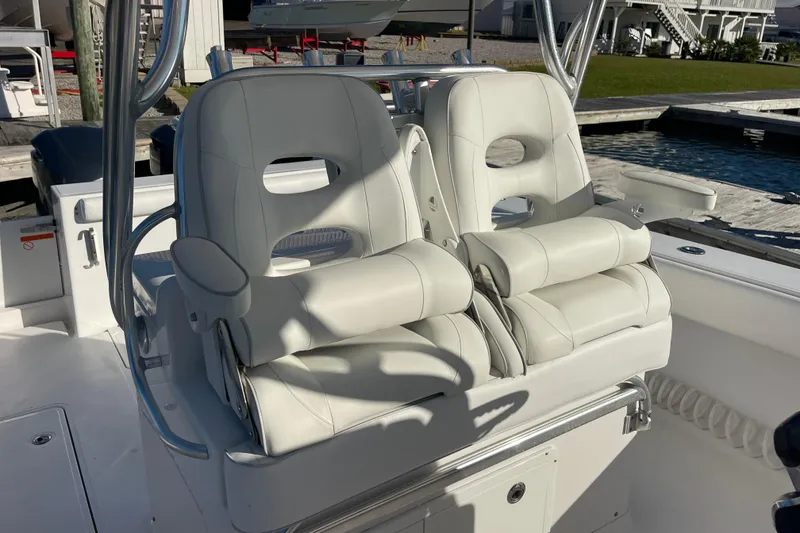 Slide: The Image of Luxury seating on 2018 Southport 33 FE boat, featuring plush white captain's chairs. - 18